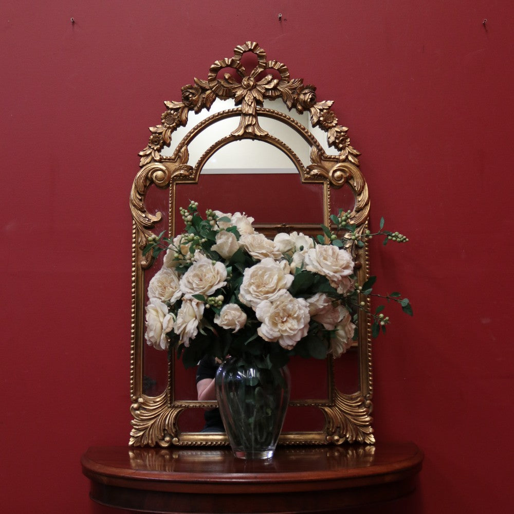 French Wall Hanging Mirror with a Heavily Ornate Gilt Frame. B12000